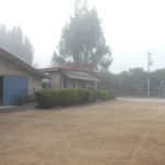 A view of the front office and barn in the fog.